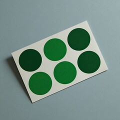 White card featuring six subtly different shades of green circles
