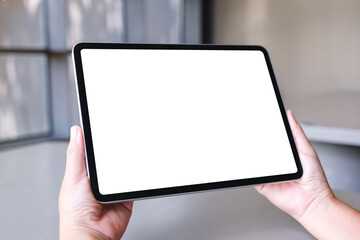 Mockup image of a woman holding digital tablet with blank white desktop screen