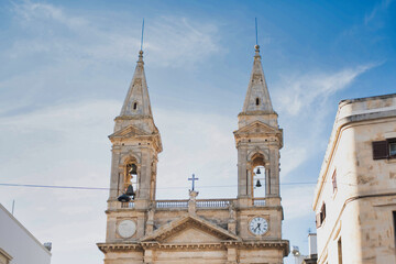 Twin spires with bell towers of church in Alberobello Italy
