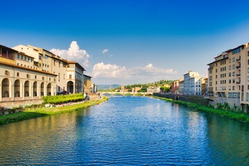 Arno river in Florence with historic buildings and cloudy sky