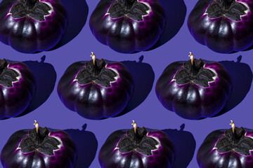 Pumpkin shaped eggplant pattern on a purple background. Vegetable violet food top view