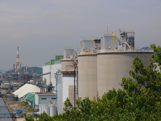 The storage tanks for materials are arranged in a line in the industrial area.