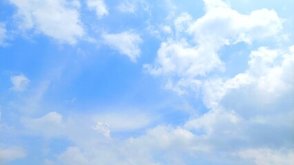 Blue sky background with white clouds in summer. Soft white clouds scattered in the blue sky. Clear blue sky, bright spring, soft sky gradient.
