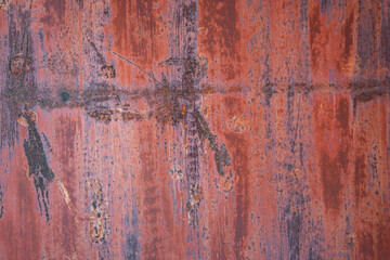 Rust on black painted metal due to environmental influences.