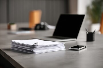 close-up of a desk in an office with documents, a laptop, and a phone on it, against a gray background, minimalistic style.