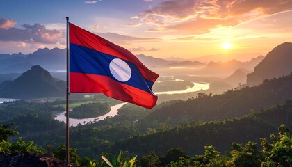Lao flag waving over scenic valley at sunset