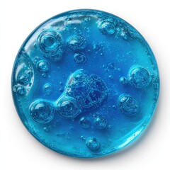 A vibrant, translucent, cerulean blue disc-shaped substance with numerous air bubbles of varying sizes trapped within, set against a stark white backdrop