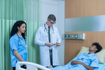 The doctor is explaining the treatment to the patient. A man lying sick in hospital.