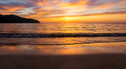Obraz premium Scenic Beach at Sunset with Vibrant Orange Sky and Reflected Light on Wet Sand