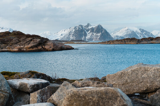 Rocky Coastline with Snow-Capped Mountains