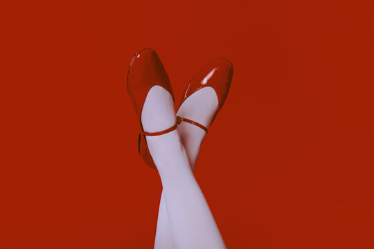 Closeup of woman legs in white socks and red ballerinas