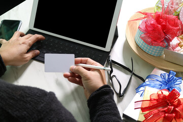 Online shopping with credit card and tablet for holiday gifts