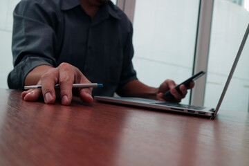 Businessman working with laptop and smartphone