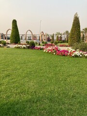 A lush park garden with a vibrant array of blossoming flowers