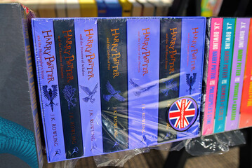 Naklejka premium Minsk, Belarus. Jan 12, 2025. Harry Potter saga books written by J.K. Rowling stacked and displayed on bookshelf in bookstore interior, classic english literature editions. Selective focus