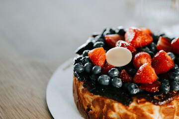 Delicious cake topped with fresh strawberries and blueberries for an afternoon treat