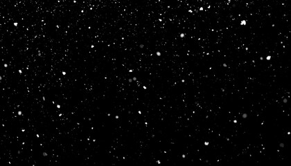 A dark night sky filled with falling snow