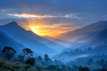 Obraz premium Majestic mountain sunrise over misty valleys and peaks illuminating the sky with warm colors