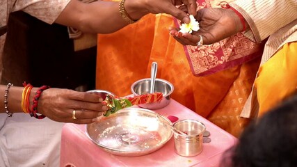 Traditional Ritual Hand Offering with Cultural Attire and Sacred Items