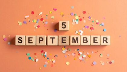 Wooden Blocks with Date 5 September. Calendar for birthday or anniversary on solid colored background with confetti
