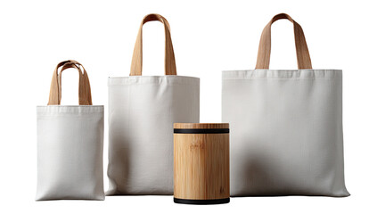 Three white canvas tote bags of varying sizes, each with light-brown wooden handles, sit beside a cylindrical, light-brown wooden object