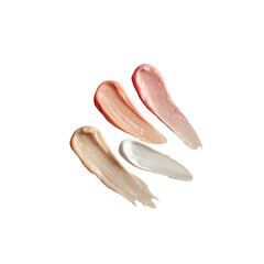 Swirls of four different tinted moisturizers, displayed in varying shades of peach, pink, beige, and white.  Creamy textures are highlighted by their smooth, soft, and slightly irregular shapes