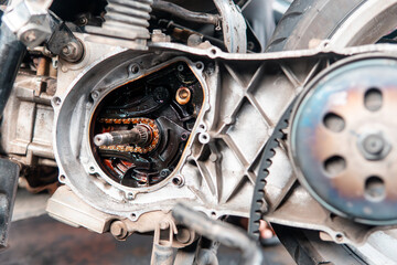 Close-up of a motorcycle engine crankcase and transmission parts exposed during repair. Showing gears, bearings, and mechanical components.