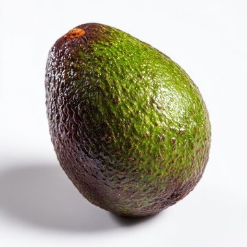 A single, ripe avocado with dark-purple bruising on one side, rests on a white background, casting a subtle shadow