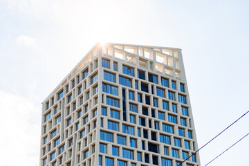 A modern business-class residential complex with unique architecture, panoramic windows, night lighting, and city views.