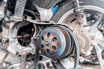 Close-up of a motorcycle engine crankcase and transmission parts exposed during repair. Showing gears, bearings, and mechanical components. 