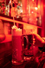 Festive drinks in bar with warm red light