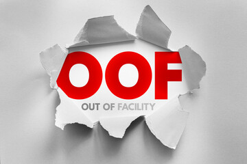OOF acronym for Out of Facility exposed through torn paper effect. Conceptual image representing absence, leave, unavailability, or remote status in a professional or business context