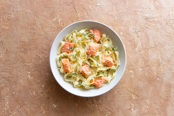 Pasta fettuccine in a creamy sauce with salmon, cheese and thyme. Italian cuisine. Healthy eating.