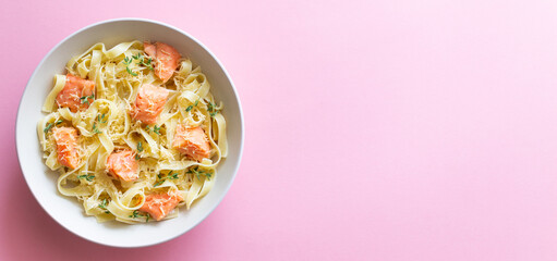 Pasta fettuccine in a creamy sauce with salmon, cheese and thyme. Italian cuisine. Healthy eating.