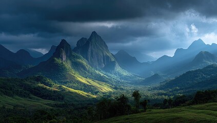 Fototapeta premium Dramatic mountain range bathed in dramatic light. Lush green valleys and peaks pierce a stormy sky