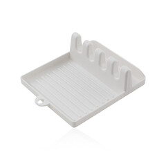 A clean white plastic kitchen utensil rest with multiple grooves, a simple and practical accessory for keeping countertops clean while cooking.