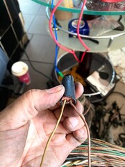 Engine Repair in Progress — Crankshaft Sensor Connector Inspected by Mechanic