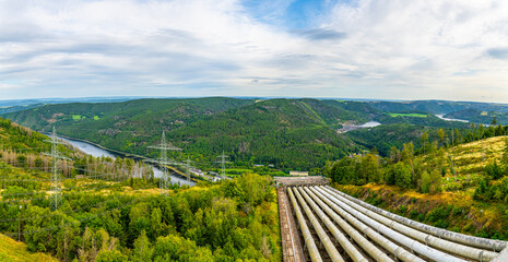 Naklejka premium Aerial view of the Hohenwarte Dam (Hohenwarte Reservoir) and the associated pumped storage facility in Thuringia, Germany. The curved concrete gravity dam rises about 75 meters.