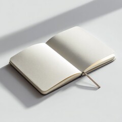 Open blank notebook with creamy pages, gray cover, subtle shadowing on a light gray surface; ribbon bookmark visible