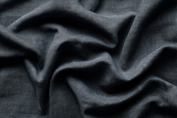 Fototapeta premium Dark fabric texture draped in soft folds showing subtle texture