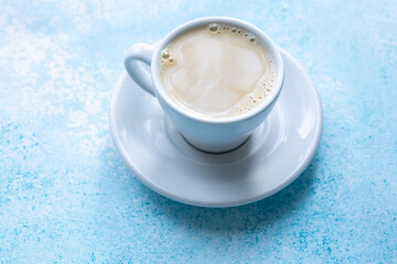  Large White Cup of Milky Coffee on a Blue Background