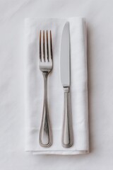Pristine silverware duet resting on a minimalist cloth canvas, embodying sophisticated dining; perfect for Gastronomy Day or Slow Food Movement