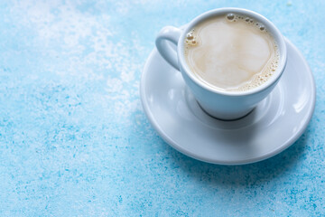 Large White Cup of Milky Coffee on a Blue Background