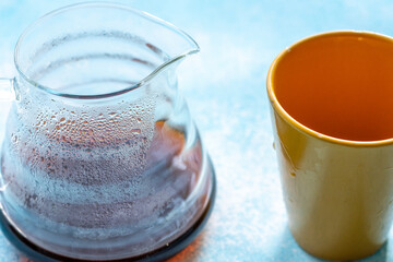 Ground Coffee and an Orange Mug on a Blue Background