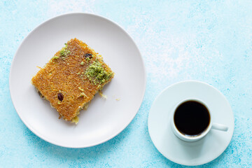 Close-Up of local Turkish Kadaif Dessert and Turkish Coffee on a Pink Plate

