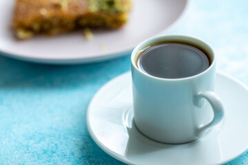 Close-Up of local Turkish Kadaif Dessert and Turkish Coffee on a Pink Plate
