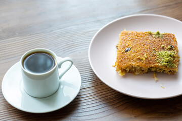 Close-Up of local Turkish Kadaif Dessert and Turkish Coffee on a Pink Plate
