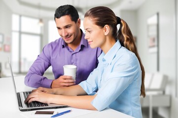 Happy young couple with laptop relaxing at home.