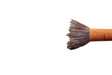 Close-up of a makeup brush, light-brown handle, fluffy grey-brown bristles