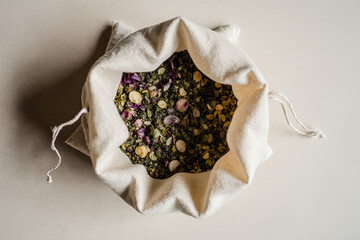Herbal linen pouch with dried flowers and aromatic botanicals on neutral background. Ideal for aromatherapy, eco packaging, wellness, and natural product visuals. AI generated.
